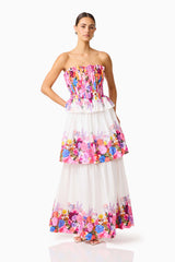 Brunette model wearing the Alice Tiered Gown in Ombre Floral posed side shot 