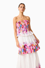 Brunette model wearing the Alice Tiered Gown in Ombre Floral posed shot 
