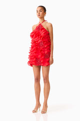 Brunette model wearing the Yvette Halter Mini Dress in Vermilion Red side shot 