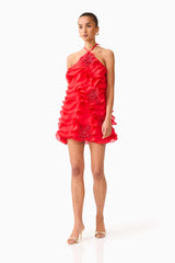 Brunette model wearing the Yvette Halter Mini Dress in Vermilion Red posed shot 