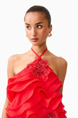 Brunette model wearing the Yvette Halter Mini Dress in Vermilion Red close up shot 