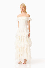 Brunette model wearing the Yvette Off Shoulder Gown in White side shot 