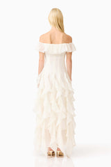 Brunette model wearing the Yvette Off Shoulder Gown in White back shot 
