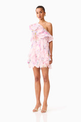 Brunette model wearing the Millie One Shoulder Mini Dress in Pink Floral side shot 

