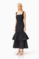 Brunette model wearing the Alexandra Tiered Gown in Black side shot 