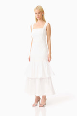 Brunette model wearing the Alexandra Tiered Gown in White side shot 
