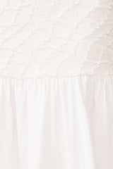 Brunette model wearing the Alexandra Tiered Gown in White detail shot 
