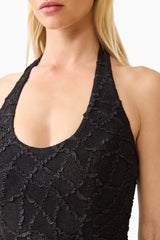 Brunette model wearing the Alexandra Halter Gown Dress in Black detail shot 
