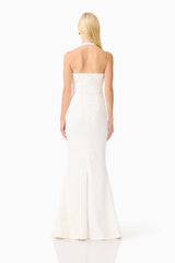 Brunette model wearing the Alexandra Halter Gown Dress in White back shot 
