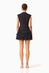 Brunette model wearing the Alexandra Tiered Mini Dress in Black back shot 
