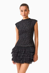 Brunette model wearing the Alexandra Tiered Mini Dress in Black posed close up shot 
