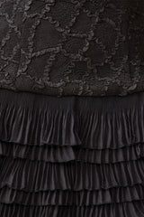 Brunette model wearing the Alexandra Tiered Mini Dress in Black detail shot 
