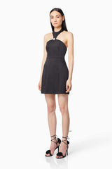 Brunette model wearing DAZZLE HALTER NECK MINI DRESS IN BLACK side shot