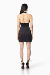 Brunette model wearing DAZZLE HALTER NECK MINI DRESS IN BLACK back shot
