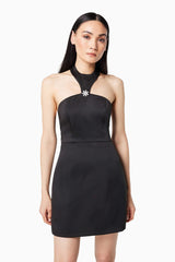 Brunette model wearing DAZZLE HALTER NECK MINI DRESS IN BLACK close up shot