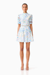 Brunette model wearing the Kalissa A-Line Mini Dress in Blue Floral front shot 
