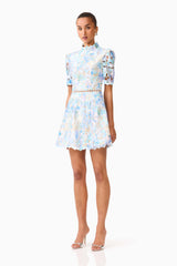 Brunette model wearing the Kalissa A-Line Mini Dress in Blue Floral side shot 