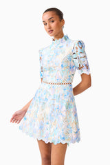 Brunette model wearing the Kalissa A-Line Mini Dress in Blue Floral close up shot 