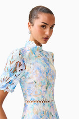 Brunette model wearing the Kalissa A-Line Mini Dress in Blue Floral side close up shot 