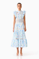 Brunette model wearing the Kalissa Ruffle Maxi Dress in Blue Floral front shot 
