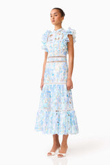 Brunette model wearing the Kalissa Ruffle Maxi Dress in Blue Floral side shot 
