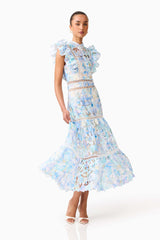 Brunette model wearing the Kalissa Ruffle Maxi Dress in Blue Floral posed front shot 
