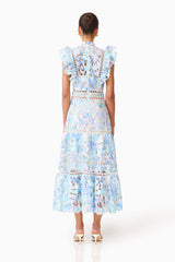 Brunette model wearing the Kalissa Ruffle Maxi Dress in Blue Floral back shot 

