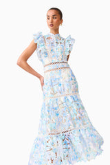 Brunette model wearing the Kalissa Ruffle Maxi Dress in Blue Floral posed shot 

