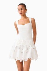 Brunette model wearing the Elizabeth A-Line Mini Dress in White campaign shot 
