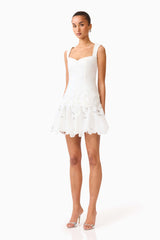 Brunette model wearing the Elizabeth A-Line Mini Dress in White side shot 
