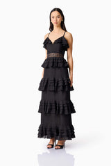Brunette model wearing the Lucinda Tiered Gown in Black side shot 