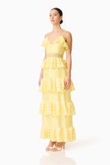 Brunette model wearing the Lucinda Tiered Gown in Lemon Yellow side shot 