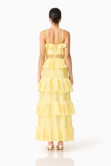 Brunette model wearing the Lucinda Tiered Gown in Lemon Yellow back shot 