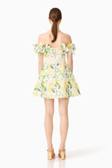 Brunette model wearing the Hana Off Shoulder Mini Dress in Lemon Print back shot