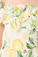 Brunette model wearing the Hana Off Shoulder Mini Dress in Lemon Print detail shot