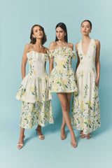 Brunette model wearing the Hana Halter Gown in Lemon Print campaign shot
