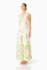 Brunette model wearing the Hana Halter Gown in Lemon Print side shot