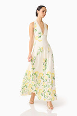 Brunette model wearing the Hana Halter Gown in Lemon Print side shot