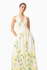 Brunette model wearing the Hana Halter Gown in Lemon Print close up shot