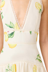 Brunette model wearing the Hana Halter Gown in Lemon Print detail shot
