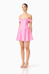 Brunette model wearing the Amelina Off Shoulder Mini Dress in Pink side shot 
