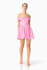 Brunette model wearing the Amelina Off Shoulder Mini Dress in Pink posed shot 