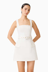 Brunette model wearing the Nydia Tulip Mini Dress in White close up shot