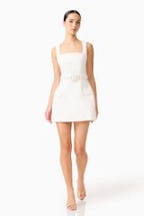 Brunette model wearing the Nydia Tulip Mini Dress in White posed walking shot