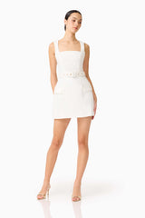 Brunette model wearing the Nydia Tulip Mini Dress in White posed looking away shot