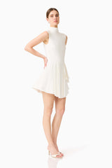 Brunette model wearing the Nydia A-Line Mini Dress in White posed hands on hips shot