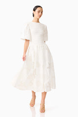 Brunette model wearing the Celine Puff Sleeve Maxi Dress in White posed shot 