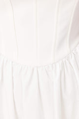 Brunette model wearing Ingrud Corset Midi Dress in White detail shot