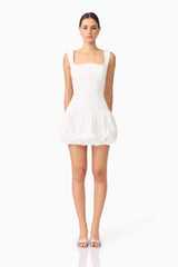 Brunette model wearing Ingrid Bubble Mini Dress in White front shot
