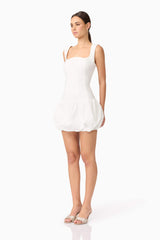 Brunette model wearing Ingrid Bubble Mini Dress in White side shot